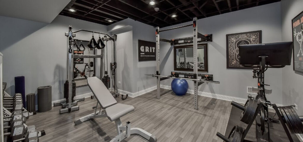 37+ Best Basement Game Room Ideas For Your Space 4 Decor elements like team jerseys and motivational posters reflect the owner's passion for fitness and sports