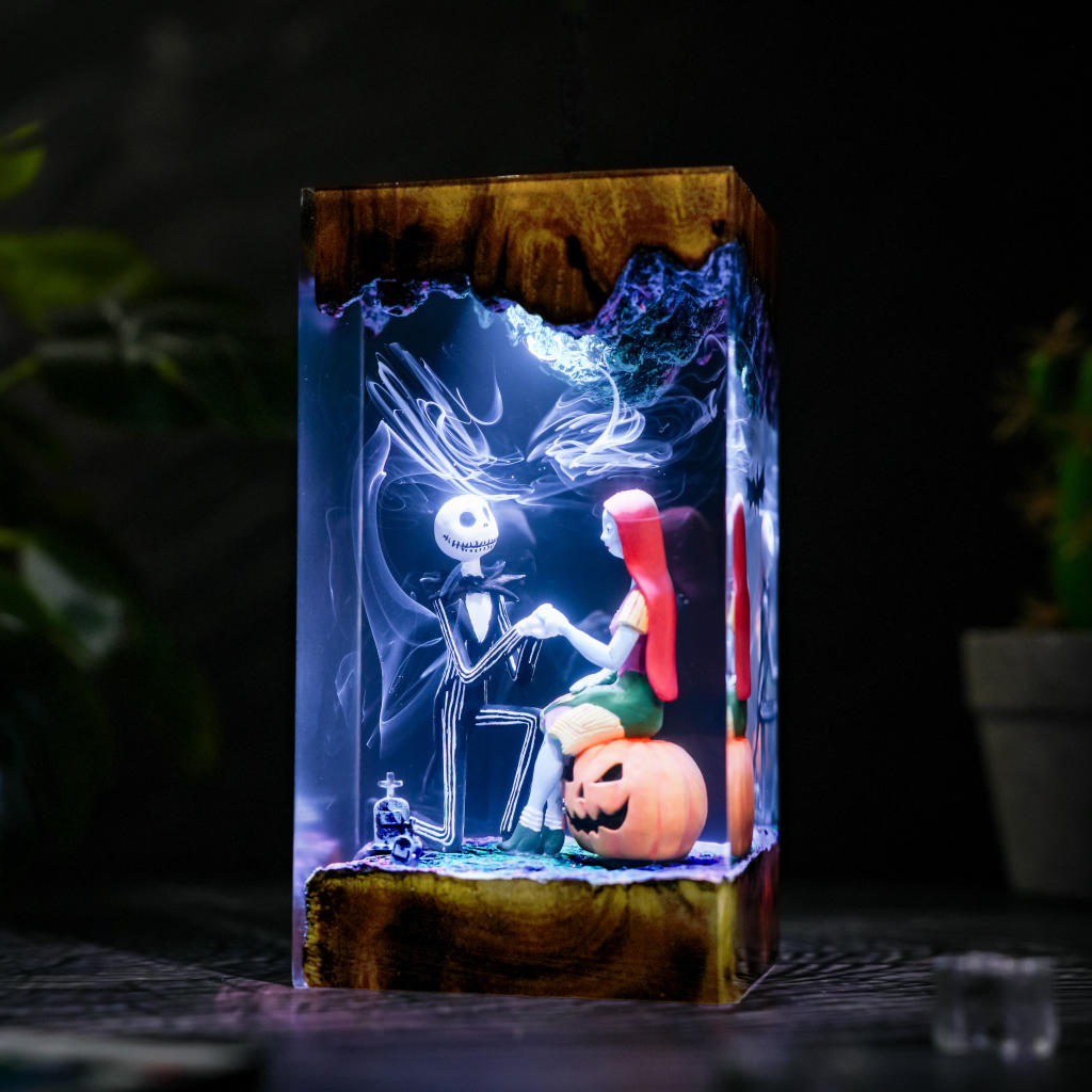 Jack Proposal Lamp - angled view showing the clear resin sides and wooden base under blue and purple lighting