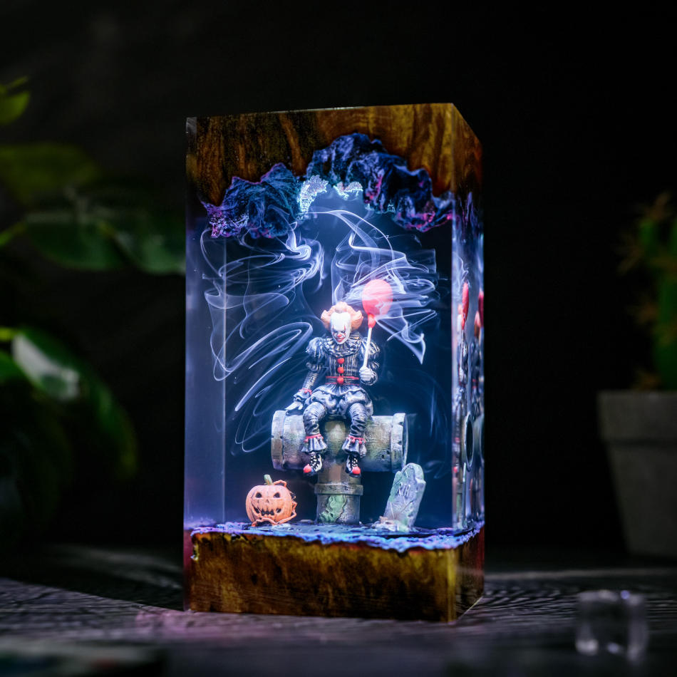 Pennywise IT Sitting On Sewer Pipe Halloween Lamp - side view with white-blue light and jack-o'-lantern