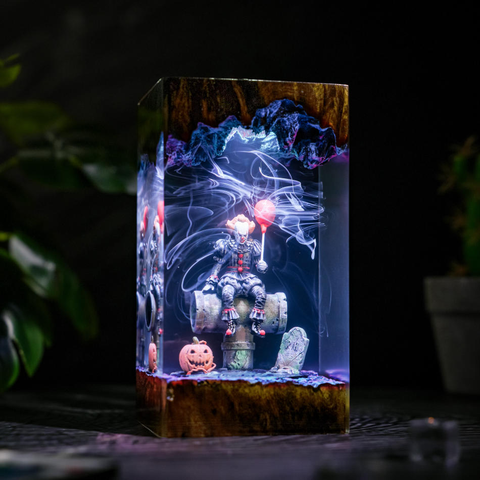 Pennywise IT Sitting On Sewer Pipe Halloween Lamp - side view with cyan-white light